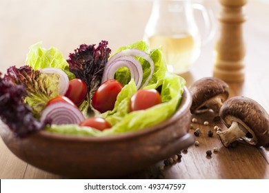 Fresh Tomato, Lettuce, And Onion Salad, On Wooden Table