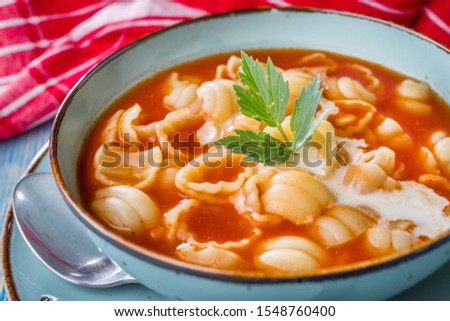 Fresh tomato soup with conchigliette in a bowl.