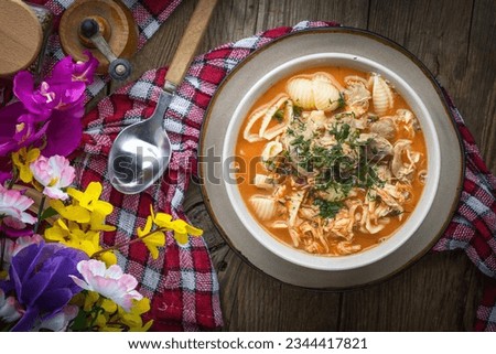 Fresh tomato soup with conchigliette in a white bowl. Top view.