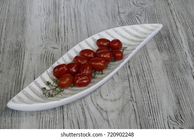 fresh tomatoes in a decorative bowl on a table - Powered by Shutterstock