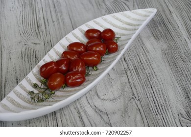 fresh tomatoes in a decorative bowl on a table - Powered by Shutterstock