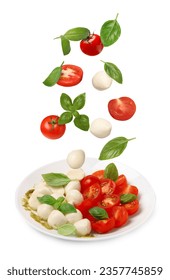 Fresh tomatoes. mozzarella cheese and basil leaves falling onto plate with Caprese salad against white background