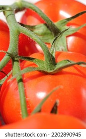 Fresh Tomatoes On A Light Background Before Cooking Closeup. Shallow Depth Of Field