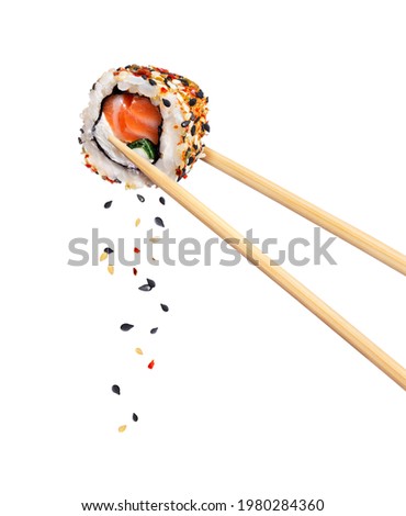 Fresh traditional japanese sushi with salmon and sesame between chopsticks, isolated on white background Stockfoto © 