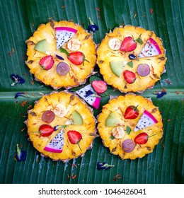 Fresh tropical fruit pizza with pineapple, strawberry, kiwi, grapes, banana and dragon fruit, Thailand. Close up, top view