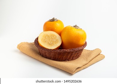 Fresh tropical fruit in a rustic bowl: cocona, white background