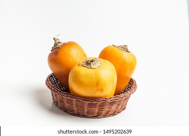 Fresh tropical fruit in a rustic bowl: cocona, white background