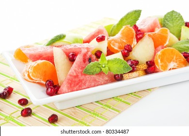 Fresh Tropical Fruit Salad In White Plate. Summer Background.