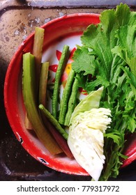 Fresh Tropical Vegetables On An Old Round Chinese Zinc Coated Tray, Served With Northeastern Thai Food (Isaan Food), Chili Dip Or Paste.