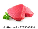Fresh tuna fish fillet steaks garnished with parsley isolated on white background