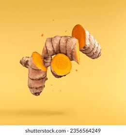 Fresh turmeric root falling in the air isolated on yellow background. Food levitation conception. High resolution image. - Powered by Shutterstock