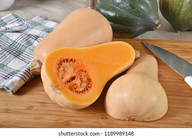 Fresh Uncooked Butternut And Acorn Squash On A Cutting Board.