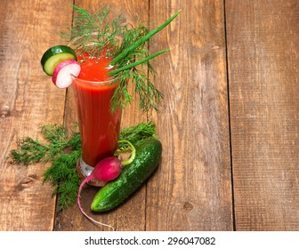 Fresh vegetable drink. Tomato juice with cucumber, radish, green onions and dill in tall glass. Wooden planks background. Copy space - Shutterstock ID 296047082