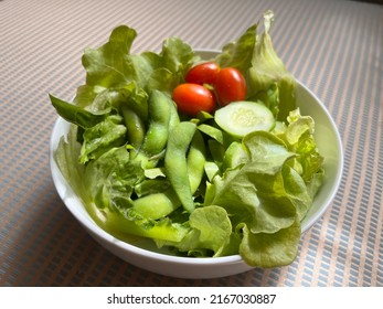 A Fresh Vegetable Edamame Beans, Tomatoes,cucumber And Green Oak Salad In A Bowl