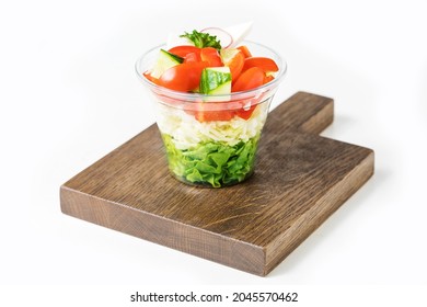 Fresh Vegetable Salad In Plastic Box Isolated On White. Fresh organic mixed green salad to go. Fst food concept.