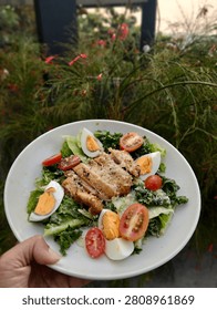 A fresh vegetable salad served with a boiled egg and crispy fried chicken - a complete, protein-rich meal packed with essential nutrients 