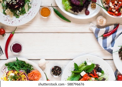 Fresh Vegetable Salads Frame Flat Lay. Top View On White Wooden Table With Free Space For Text Between Side Dish Buffet. Vegetarian Cuisine, Menu Concept