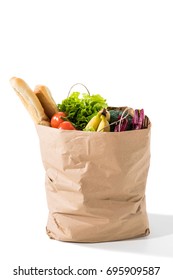 fresh vegetables, baguettes and bananas in grocery bag isolated on white