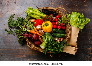 Fresh Vegetables In Basket On Wooden Background