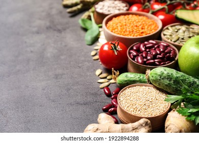 Fresh vegetables, fruits and seeds on grey table, space for text