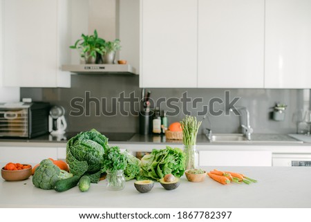 Fresh vegetables in the process of preparing a delicious and healthy vegan dish. Fresh vegetables on the countertop, kitchen on the background.