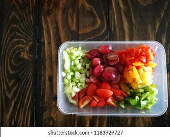 Fresh Vegetables Salad And Fruits In A Plastic Container, Ingredients For Making Pasta Salad On A Wooden Table.