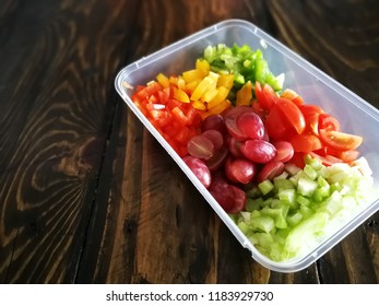 Fresh Vegetables Salad And Fruits In A Plastic Container, Ingredients For Making Pasta Salad On A Wooden Table.