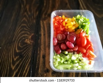 Fresh Vegetables Salad And Fruits In A Plastic Container, Ingredients For Making Pasta Salad On A Wooden Table.