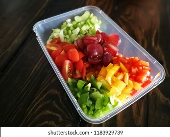 Fresh Vegetables Salad And Fruits In A Plastic Container, Ingredients For Making Pasta Salad On A Wooden Table.