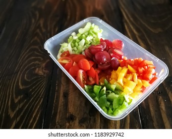 Fresh Vegetables Salad And Fruits In A Plastic Container, Ingredients For Making Pasta Salad On A Wooden Table.