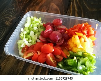 Fresh Vegetables Salad And Fruits In A Plastic Container, Ingredients For Making Pasta Salad On A Wooden Table.