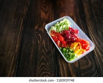 Fresh Vegetables Salad And Fruits In A Plastic Container, Ingredients For Making Pasta Salad On A Wooden Table.