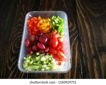 Fresh Vegetables Salad And Fruits In A Plastic Container, Ingredients For Making Pasta Salad On A Wooden Table.