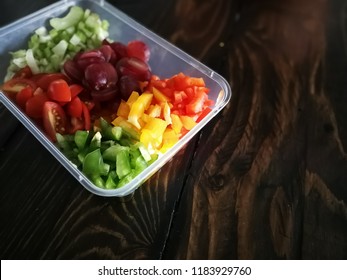 Fresh Vegetables Salad And Fruits In A Plastic Container, Ingredients For Making Pasta Salad On A Wooden Table.