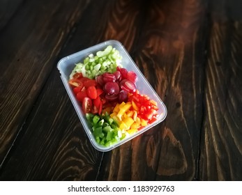 Fresh Vegetables Salad And Fruits In A Plastic Container, Ingredients For Making Pasta Salad On A Wooden Table.