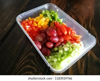 Fresh Vegetables Salad And Fruits In A Plastic Container, Ingredients For Making Pasta Salad On A Wooden Table.