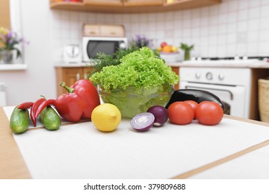 Fresh vegetables for salad on a kitchen table.