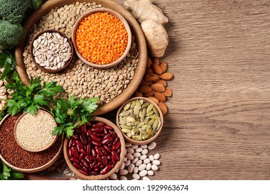 Fresh vegetables and seeds on wooden table, flat lay. Space for text