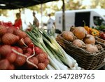 Fresh vegetables at small local urban market. Organic produce on sale at outdoor farmer market. Selling fresh crops and veggies harvest. European urban setting. Close up. Part of the series.