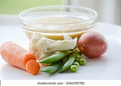 Fresh vegetables and soup-puree on a children's table. children's menu