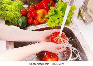 Fresh vegetables under water stream in colander - Powered by Shutterstock