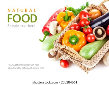 Fresh vegetables in wicker basket. Isolated on white background