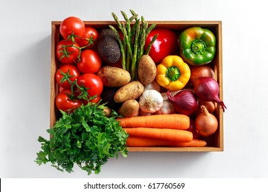 Fresh Vegetables in wooden box on white wooden background