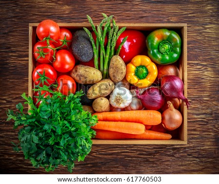 Fresh Vegetables in wooden box on wooden background