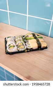 Fresh Vegetarian Sushi Take Away On Wooden Surface And Blue Tile Background, With Copy Space, Healthy Snack, Set Lunch, No People