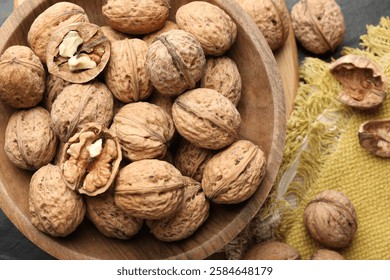 Fresh walnuts in shells on table, flat lay