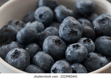 Fresh washed blueberries in white bowl closeup, shallow focus - Shutterstock ID 2223983441