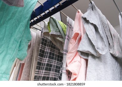 Fresh Washed Linen, Clothes Hanging On A Dryer, Dry Apparel On A Folding Portable Dryer Close Up, Housekeeping, Homework And Chores Concept.