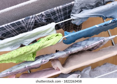 Fresh Washed Linen, Clothes Hanging On A Dryer, Dry Apparel On A Folding Portable Dryer Close Up, Housekeeping, Homework And Chores Concept.