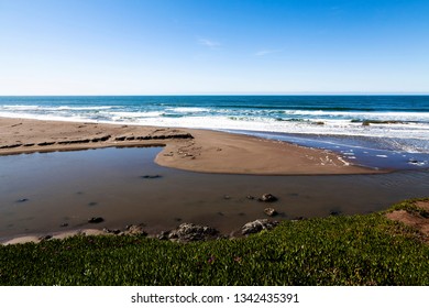 Fresh Water Flowing Into Ocean With Green Ice Plants And Blue Sky Northern California